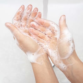 washing-soap-foam-from-her-hands-running-water